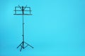 Empty music note stand on color background Royalty Free Stock Photo
