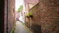 Empty Narrow Medieval Street Between Brick Houses In Bruges, Belgium Royalty Free Stock Photo