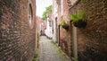 Empty Narrow Medieval Street Between Brick Houses In Bruges, Belgium Royalty Free Stock Photo