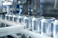 Empty new aluminum cans for drink process in factory line on conveyor belt machine at beverage manufacturing. food and Royalty Free Stock Photo