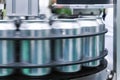 Empty new aluminum cans for drink process are moving in factory line on conveyor belt machine at beverage manufacturing. food and Royalty Free Stock Photo