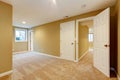 Empty new bedroom with many doors and beige carpet.