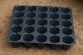 Empty and new seedling tray used as growing trays for seeds. Germination tray or nursery tray kept on ground with empty slots for Royalty Free Stock Photo