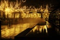 Empty night restaurant, lot of tables and chairs with noone, magic fairy lights on trees like christmas celebration