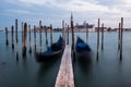 Empty, no tourists Venice. Gondolas moored by Saint Mark square with San Giorgio di Maggiore church in Venice Royalty Free Stock Photo