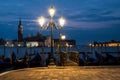 Empty, no tourists Venice. Gondolas moored by Saint Mark square with San Giorgio di Maggiore church Royalty Free Stock Photo