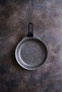 Empty nonstick serving pan on dark textured background, close-up, top view