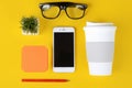 Empty note paper with plastic cup of coffee, pen, phone and glasses Royalty Free Stock Photo