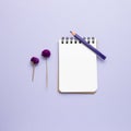 Empty notebook colored pencil dry flowers on purple background