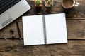 Empty notebook and computer on wooden table Royalty Free Stock Photo