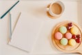 Empty notebook with cup of coffee and dessert on table. Royalty Free Stock Photo
