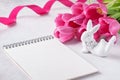 Empty notebook, cute Easter bunny and pink tulips Royalty Free Stock Photo