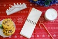 Empty notebook for desires and Christmas cookies with chocolate on a red napkin