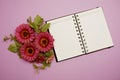 Empty Notebook with flower bouquet on purple background Royalty Free Stock Photo