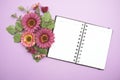 Empty Notebook with flower bouquet on purple background Royalty Free Stock Photo
