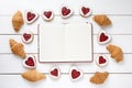 Empty notebook frame for design text, croissants and heart shaped cookies composition on Valentines Day Royalty Free Stock Photo