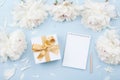 Empty notebook and gift or present box decorated white peony flowers on pastel table top view. Flat lay composition for birthday Royalty Free Stock Photo