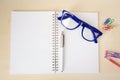 Empty notebook with office accessories and blue frame eye glasses Royalty Free Stock Photo