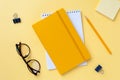 Empty notebook and office stationery yellow background. Royalty Free Stock Photo