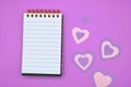 empty notebook on purple background with hearts Royalty Free Stock Photo