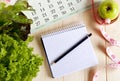 Empty notebook with vegetable salad and apple Royalty Free Stock Photo
