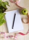 Empty notebook with vegetable salad and apple Royalty Free Stock Photo
