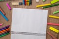 Empty notepad with color chalks and pencils Royalty Free Stock Photo
