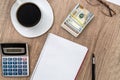 Notepad with pen, calculator, coffee and dollar Royalty Free Stock Photo