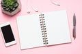 Empty notepad, smartphone and cactus on pink top view. Royalty Free Stock Photo