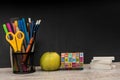 Empty notepad on teacher desk against  chalkboard. education concept Royalty Free Stock Photo