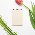 Empty notepad with tulip flower on white background Royalty Free Stock Photo