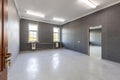 Empty Office Room with Grey Walls and Bright Windows Royalty Free Stock Photo
