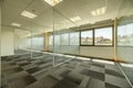 Empty offices with several glass partitions separating cubicles, long windows Royalty Free Stock Photo