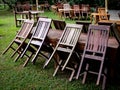 Empty old abandoned wooden dining table set on the green yard garden. Royalty Free Stock Photo