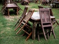 Empty old abandoned wooden dining table set on the green yard garden. Royalty Free Stock Photo