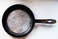 Empty old cast iron frying pan isolated on white background. Royalty Free Stock Photo