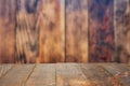 Empty old Dark wooden rustic table top made of planks with uneven edges on grunge rustic vintage dark textured wooden background.