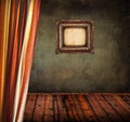 Empty old grunge room with curtain and blank vintage frame Royalty Free Stock Photo