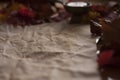 Empty old paper with a candle and leafs on wooden table Royalty Free Stock Photo