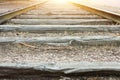 Empty old railroad track with weathered wood planks in perspective golden sunlight on horizon low angle shot. Life destiny Royalty Free Stock Photo
