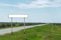 Empty old road sign for the name of a city or village populated area near the road in the countryside against a blue sky Royalty Free Stock Photo