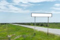 Empty old road sign for the name of a city or village populated area near the road in the countryside against a blue sky Royalty Free Stock Photo