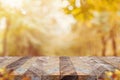 Empty old rustic wood plank table top with blur forest tree with sunlight,Autumn fall backgorund,Mock up for display or montage of Royalty Free Stock Photo