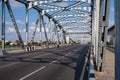 Empty old steel structure bridge over the river on clouds blue sky background Royalty Free Stock Photo