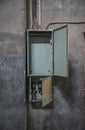 Open distribution panel box on concrete wall in abandoned building Royalty Free Stock Photo
