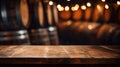 Empty old wood table on blurred wine cellar background, vintage desk in room with barrels and lights. Wooden casks in storage of