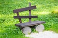 Empty old wooden bench on a green lawn. Garden or park, outdoors Royalty Free Stock Photo