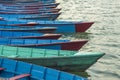 A empty old wooden blue red green boats on the water stand in a row Royalty Free Stock Photo