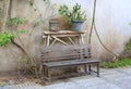 Empty of Old wooden chair in the garden against old cement wall background Royalty Free Stock Photo