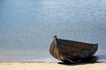 Empty old wooden rowboat on the beach